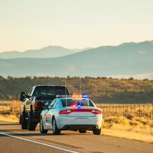 police car pulling over a truck